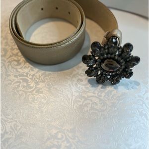 Beige leather belt with crystal flower buckle.